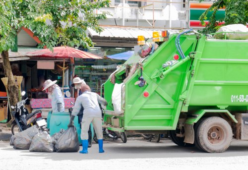 Workers using mechanical aids and PPE during a clearance operation